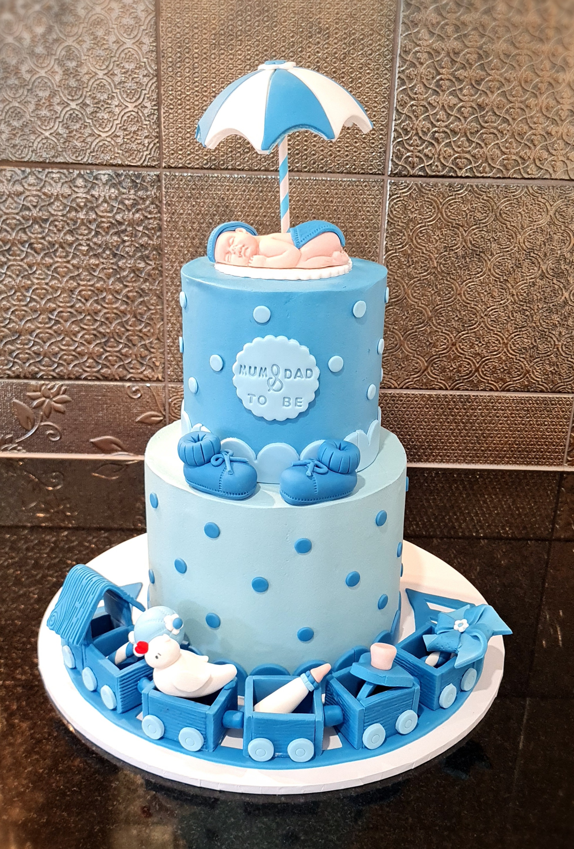 Blue Baby Shower Cake with Sleeping Baby and Toy Train decoration