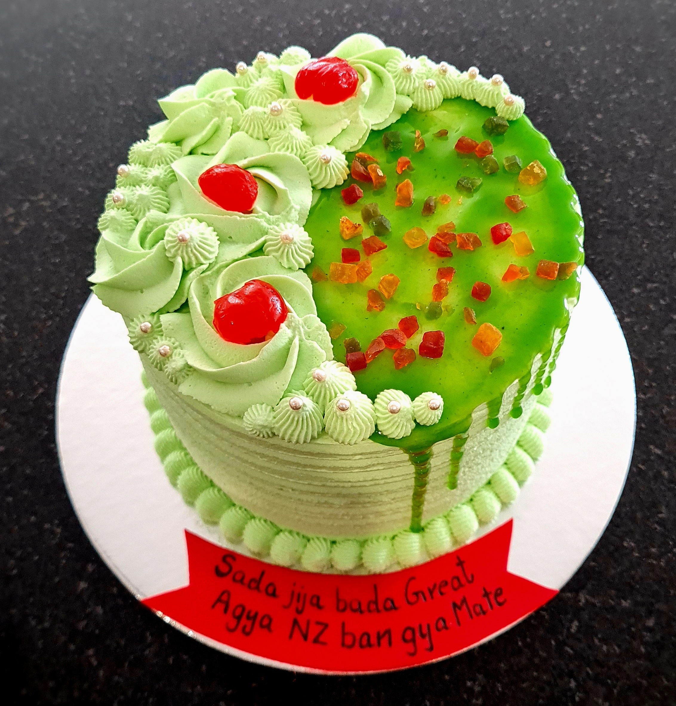 Paan Flavor Fresh Cream Cake with green cream roses and colorful decorations for traditional celebration