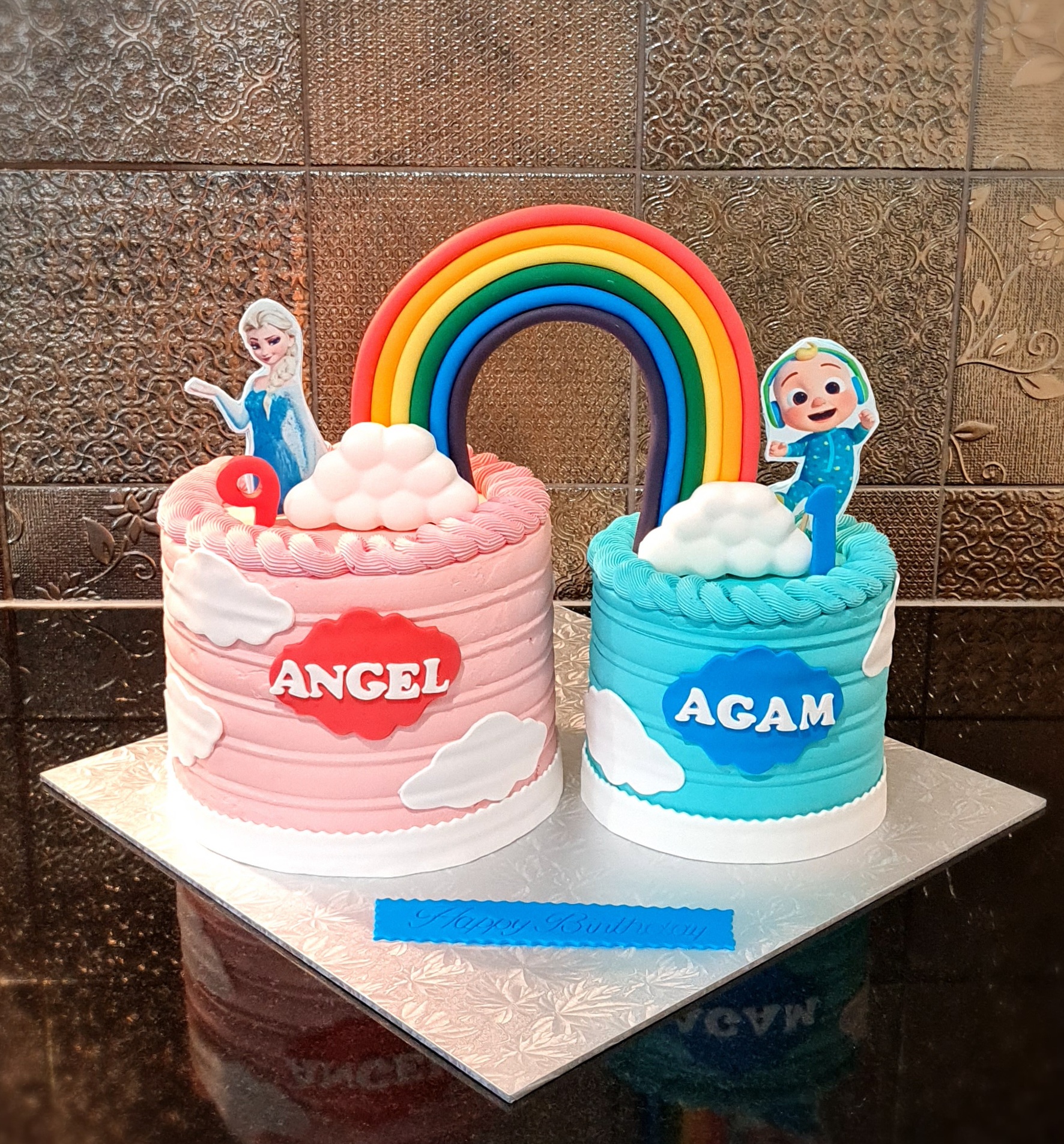 Frozen and Cocomelon Twin Birthday Cakes with Rainbow design